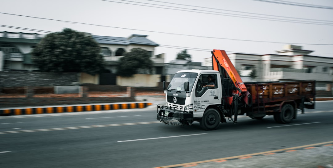a-truck-driving-down-the-road-xgqjwdsesa0